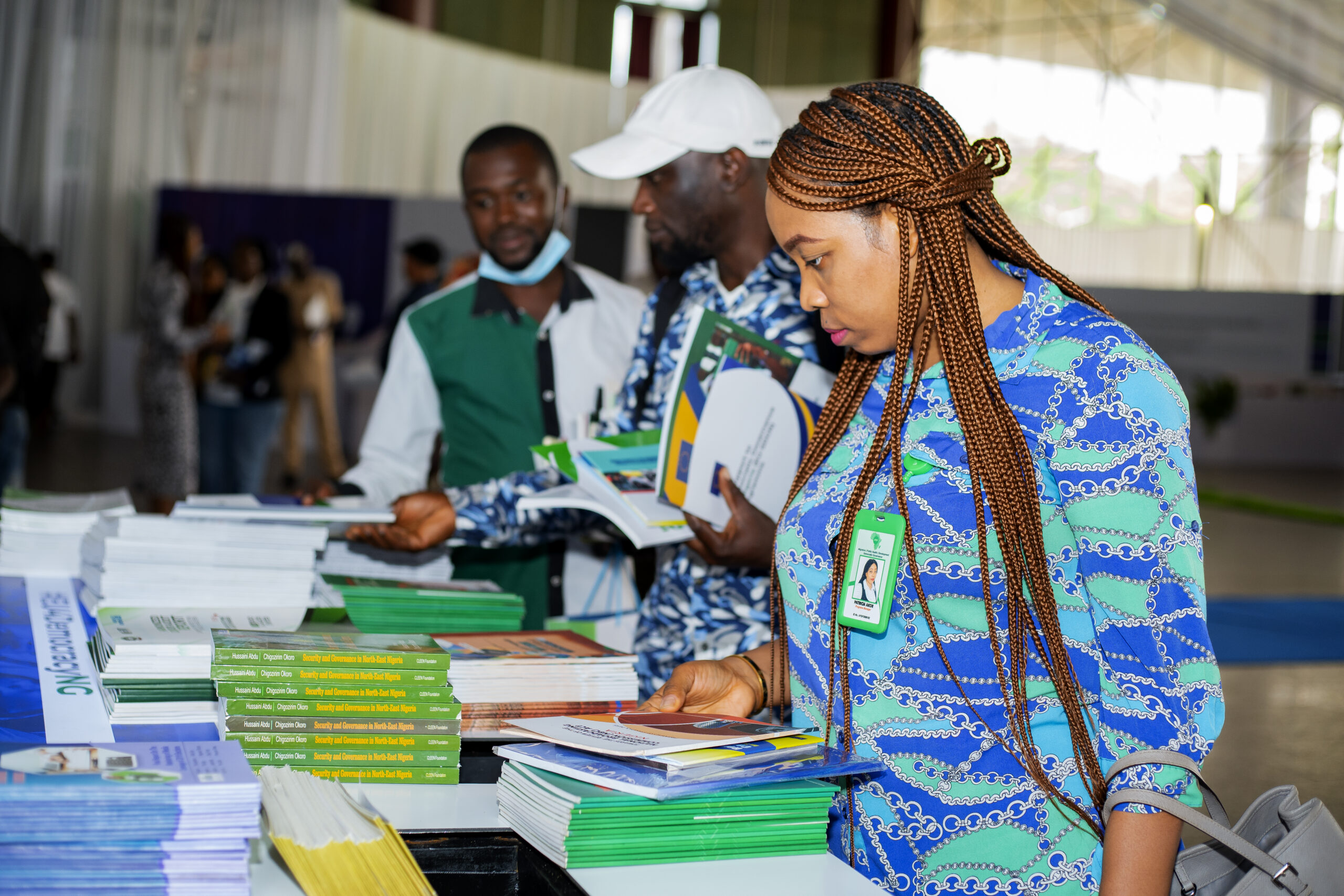 Patricia Akor -Head of Programmes-AYGF selecting free books and reports at the event market place.