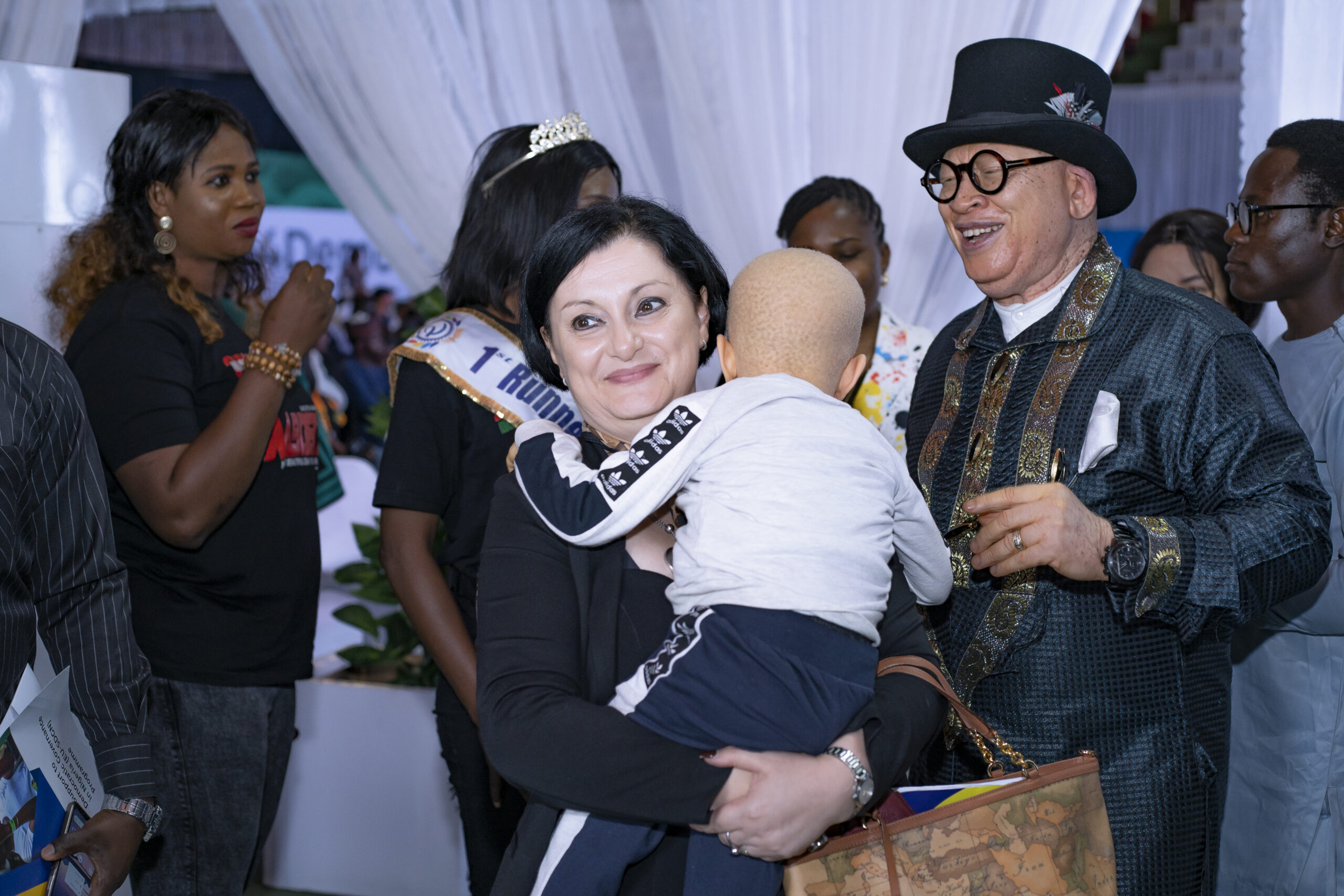 The passionate EU Ambassador hugging a child at the event